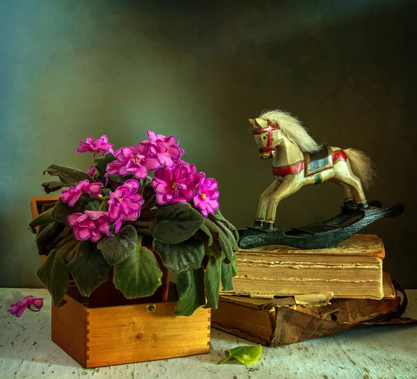 Still Life Blooming Violet Wooden Toy Horse Old Books Vintage — Stock Photo, Image