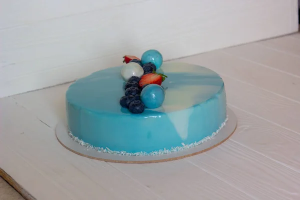 Blue icing mousse cake with berries