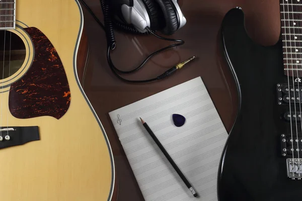 Guitars, studio earphones and musical leaf