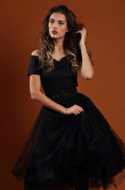 Portrait of a beautiful slender girl in a black dress