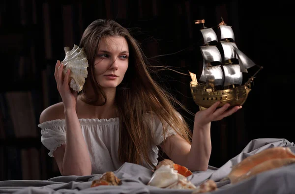 A girl with a model of a sailboat, in the form of an allegory of — Stock Photo, Image