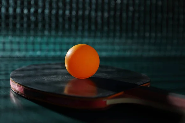 Racket and ball for table tennis on the green table