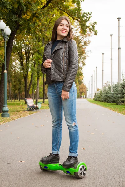 Young  woman riding hoverboard - electrical scooter, personal eco transport. — ストック写真