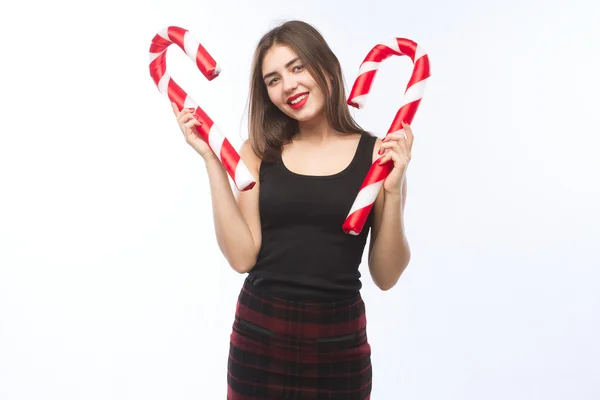 Young beautiful girl with red lips with christmas candy on isolated white background. — ストック写真