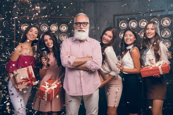Christmas happy party! New Year 2018! Group of attractive girls and happy modern and fashion Santa. Party with gifts and champagne. People dancing in gold confetti and give gifts