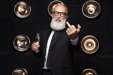 Business man show a fuck to camera while drinking alcohol champagne. Confident and successful millionaire. Satisfied of him fucking emotions