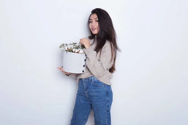 Portrait of beautiful Asian girl with holding a composition of New Yer's gift box. Modern gift to parents and friends. Posing of attractive and confident woman — Stock Photo, Image