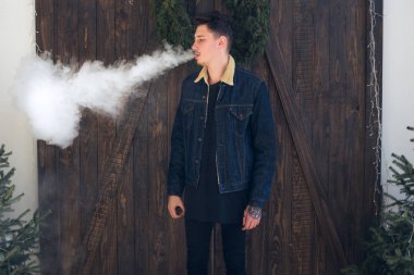 Sakal vaping elektronik sigara ile genç adam. 