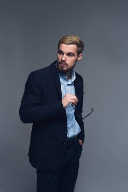 Şık ve kendinden emin. Öte yandan pantolon cebine attı ve gözlük tutarak iş kişinin bir portre.