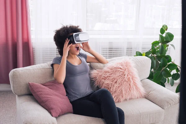 See the world in other way! Good-looking gorgeous young female watching the imaginary world in 3D glasses, while sitting at home.