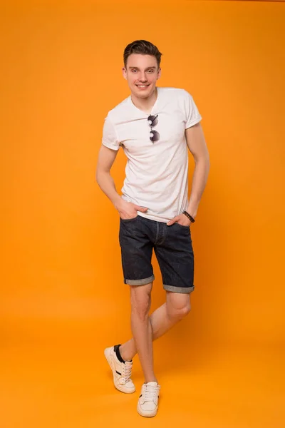 Summer is the state of mind! Full length picture of the smart male model posing at the camera, while wearing summer style clothes.