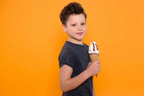 놀 아 요! 잘생긴 작은 즐거운 아이 그림에 대 한 카메라에 포즈를 취하 하 고 격리 된 배경 위에 여름에 아이스크림 경적을 먹는. — 스톡 사진