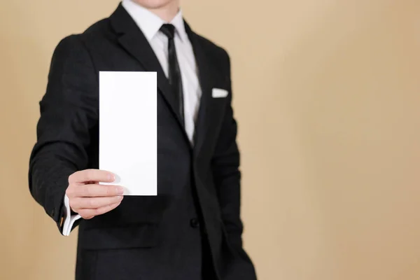 Man showing blank black flyer brochure booklet. Leaflet presenta — Stock Photo, Image