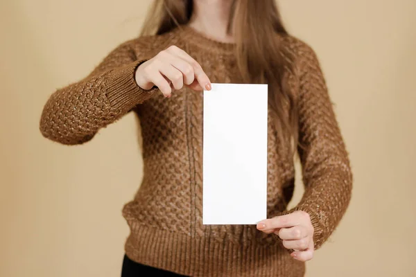 Дівчина, що показує порожній білий брошура-фуршет. Листковий подарунок — стокове фото