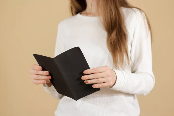 Girl reading blank black flyer brochure booklet. Leaflet present — Stock Photo, Image