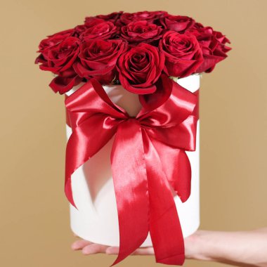 Man hand holding rich gift bouquet of 21 red roses. Composition  clipart