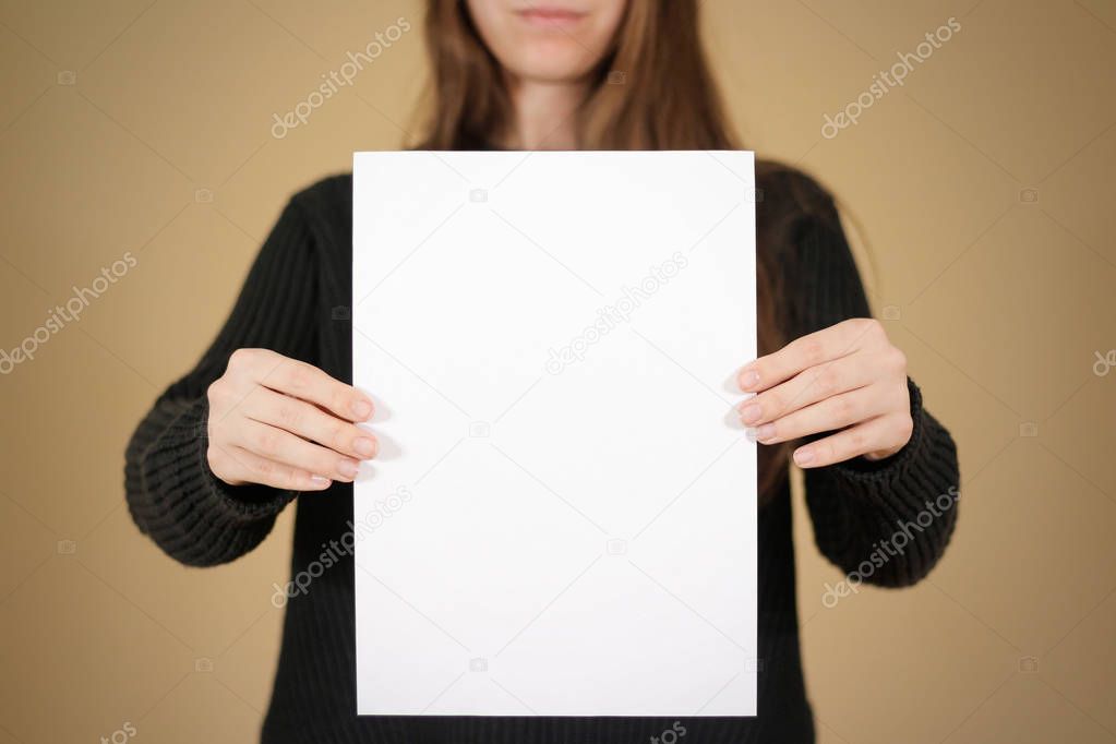 Girl holding white A4 blank paper. Leaflet presentation. Pamphle