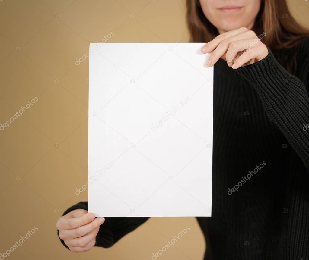 Girl holding white A4 blank paper. Leaflet presentation. Pamphle