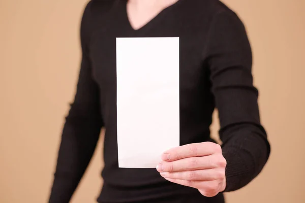 Man showing blank white big A2 paper. Leaflet presentation. Pamp Stock  Photo by ©onlyblacktv.bk.ru 146432985