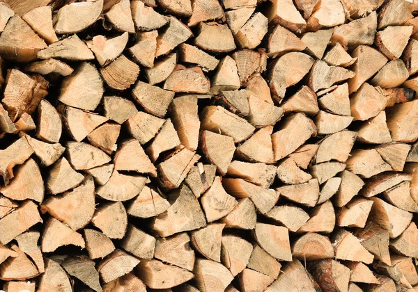 Stack of firewood - wooden abstract background — Free Stock Photo