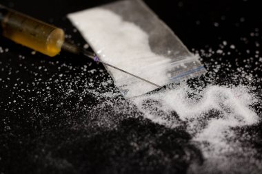 İlaç şırınga ve pişmiş eroin. Dağınık çantada kokain. Ben