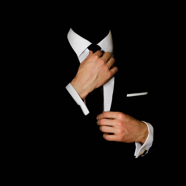 Man in a black suit and white shirt and black tie on a black bac — Stock Photo, Image