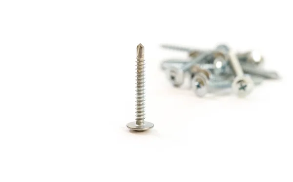 Set of metal screws on the white background — Stock Photo, Image