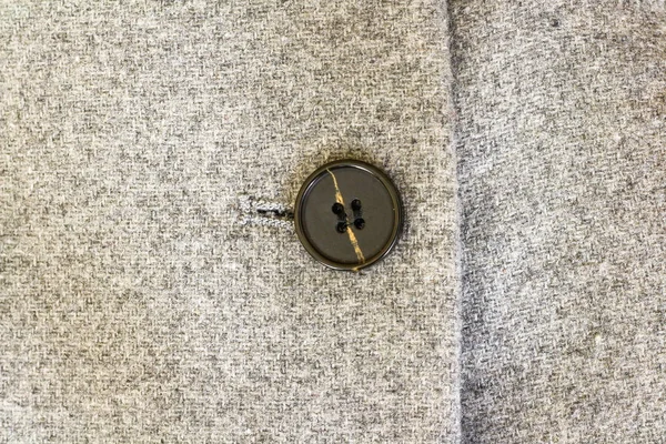 Textura de tweed cinza, botões pretos em um casaco de lã cinza . — Fotografia de Stock