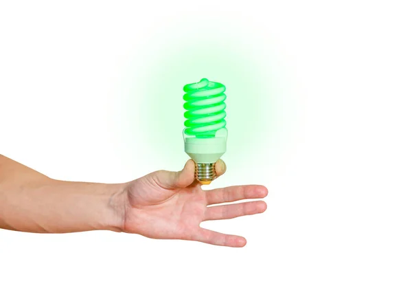Крупный план руки человека, держащего энергосберегающую лампу. Светится ярко — стоковое фото