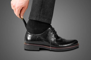 Wearing black shoes with a spoon. Isolated on white background clipart