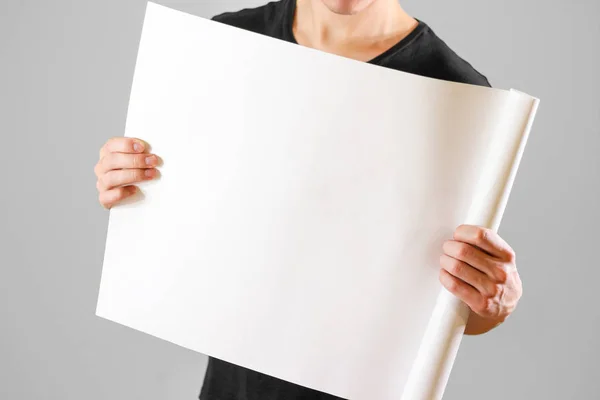 Man showing blank white big A2 paper, covers the face. Leaflet p Stock  Photo by ©onlyblacktv.bk.ru 146433113
