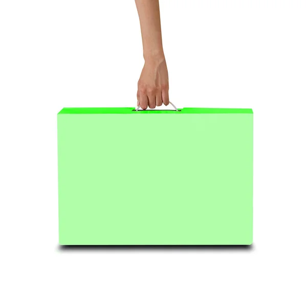 Die Hand hält eine grüne Schachtel mit einem Griff. Verpackungsbox für Laptop. ist — Stockfoto