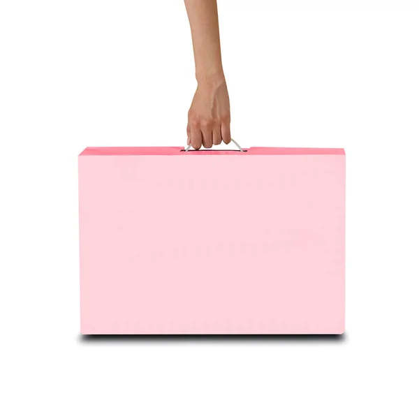 Mano tiene una scatola rosa con una maniglia. Scatola di imballaggio per laptop. Iso. — Foto Stock