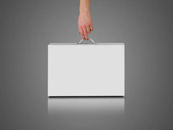 Hand hält eine weiße Schachtel mit Griff. Verpackungsbox für Laptop. ist — Stockfoto
