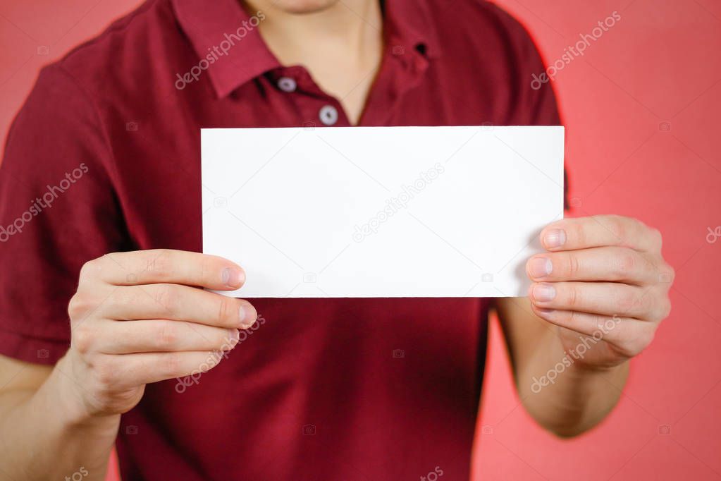 Man showing blank white flyer brochure booklet. Leaflet presenta