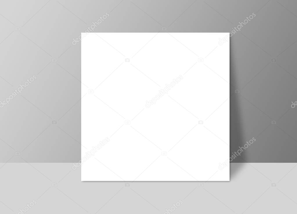 White blank stationary near the grey wall with shadow. Close up 