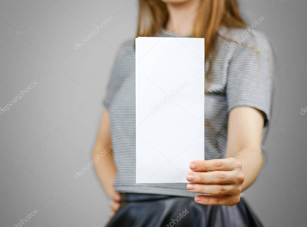 Woman showing blank white flyer paper. Leaflet presentation. Pam