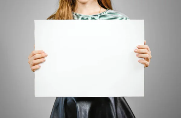 Woman showing blank white big A2 paper. Leaflet presentation. Pa — Stock Photo, Image