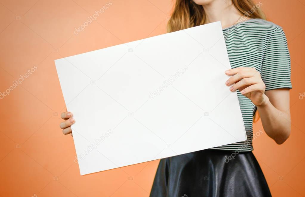 Woman showing blank white big A2 paper. Leaflet presentation. Pa