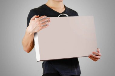 Siyah tişörtlü adam beyaz kutu kulplu tutar. Bo ambalaj