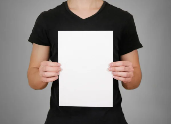 Man showing blank white big A2 paper, covers the face. Leaflet p Stock  Photo by ©onlyblacktv.bk.ru 146433113