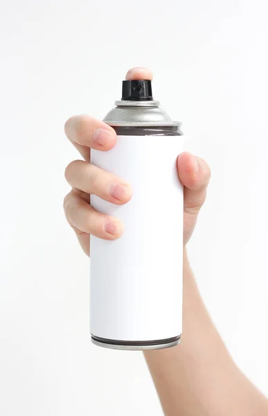 Iemands hand houdt een spray van zwarte verf. Geïsoleerd op een witte bac — Stockfoto