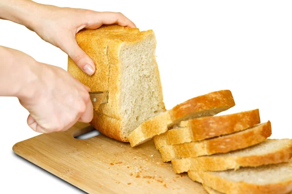 As mãos da menina com uma faca fatiada pão dourado. Isolados em w — Fotografia de Stock