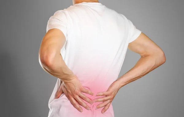 A man holds back. Pain in the lower back. Andros. Sore point hig — Stock Photo, Image