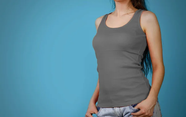 A girl in a grey plain t-shirt. Empty tank top. Closeup. Isolate