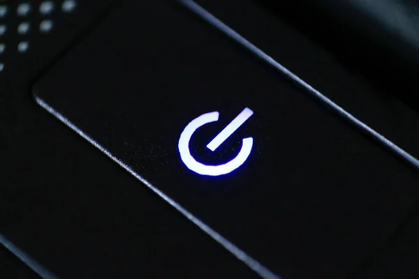 Black button start flashing blue light. Closeup — Stock Photo, Image