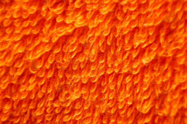 Textur des Stapels aus orangefarbenem Stoff. Makro. Nahaufnahme. isoliert auf einem — Stockfoto