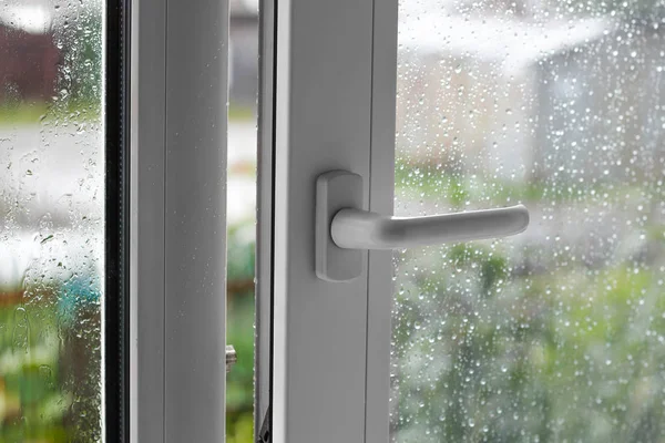 Open white plastic window. In the rainy weather. Closeup — Stock Photo, Image