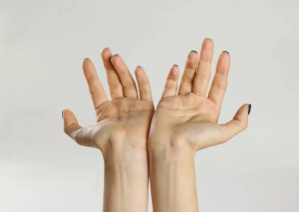 Two female hands. Isolated on gray background. The palm closeup — Stock Photo, Image