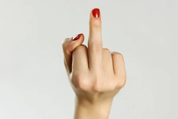 Female hand shows middle finger. Isolated on gray background. Cl — Stock Photo, Image